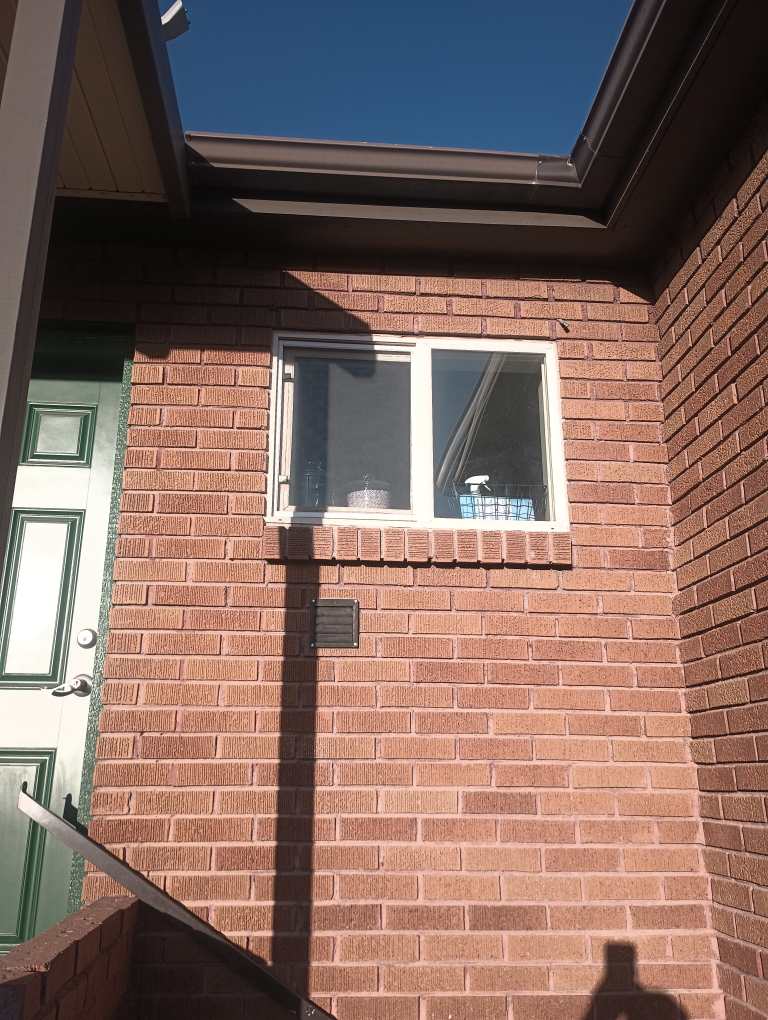 Kitchen window screen repair on a Southern Utah brick home